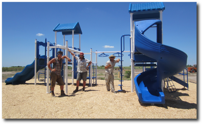 men installing playground equipment 