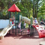 Kids playing on a playground on safety surface