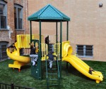 Kids playing on a playground on artificial turf