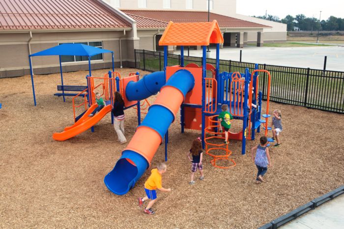 kids playing on playground outside of daycare center 