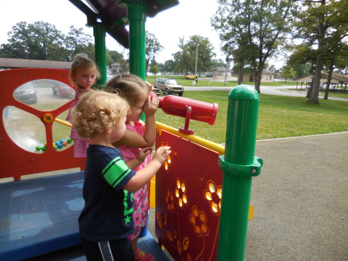 Children playing with a discovery panel