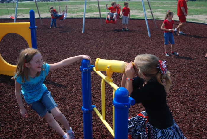 two young students playing on playground