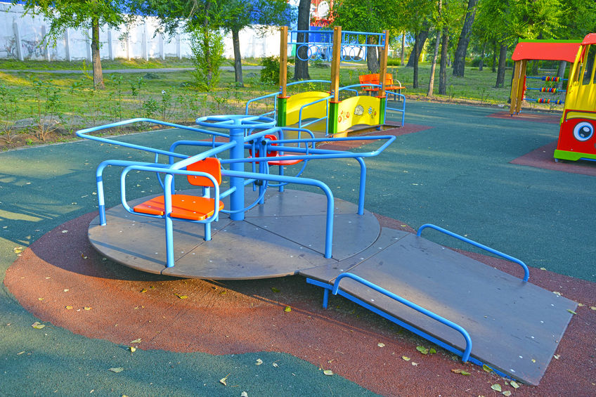 Children revolving carousel in the park for children with disabilities