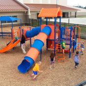 kids playing on playground outside of daycare center